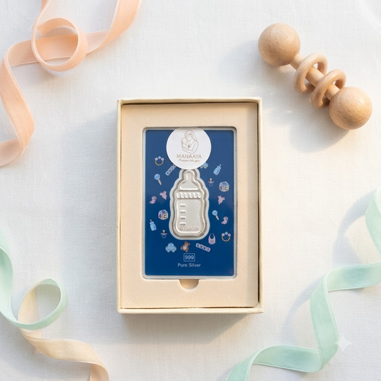 Manaaya milk bottle-shaped silver coin on a blue card in a cream gift box